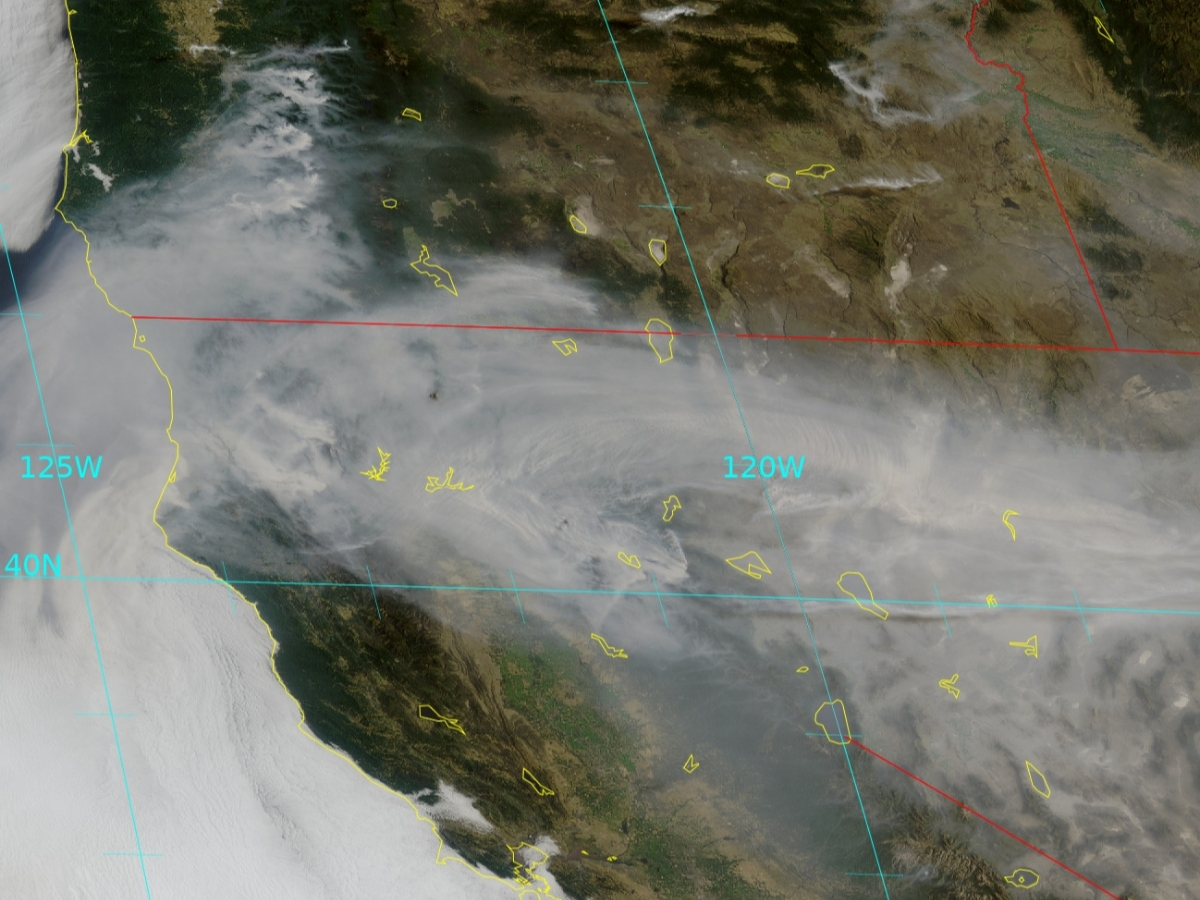 A satellite image shows wildfires sending up plumes of smoke in Oregon and California on Tuesday. Forecasters said a pool of smoke may make the trip north by late in the week.