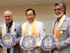 Dr. Hong, Tao-Tze, president of the Federation of World Peace and Love, center, presents the compass clock of conscience to Bahrain's Cabinet Affairs Minister Mohammed Bin Ibrahim Al Mutawa, left, and Shaikh Hussam bin Essa Al Khalifa.