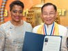 Dr. Hong, Tao-Tze, president of FOWPAL, is presented with a letter of appreciation from Mayor of the District of Columbia Muriel Bowser by Mayor Cashenna Cross of Glenarden, MD., left, for hosting bell ringing ceremonies in Washington on March 28. 