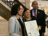 Titciana Barros, Principal of Roxbury Prep High School, receives commendation from Rep. Liz Miranda at the Boston statehouse on Tuesday. Rep. Holmes also joined to congratulate Barros. 