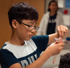 A student working on the strawberry dna lab for one of SAFE's summer camps