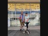 C.A.R.L. Thrift Store shopper Bill and his dog Panda stand with C.A.R.L. volunteer and Governance Board President Claudia Hoste 