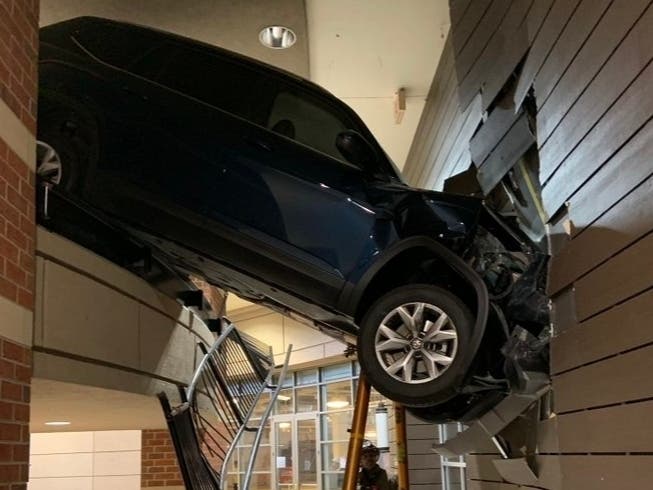 A woman was rescued Wednesday afternoon in Buckhead after her SUV fell off the side of a parking deck. Atlanta Fire Rescue was called to the scene.