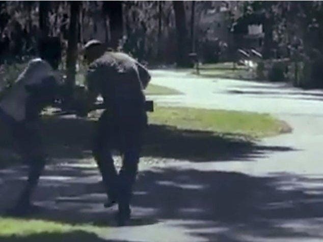 Ahmaud Arbery struggles (left) with Travis McMichael over a shotgun on the street in a neighborhood outside Brunswick, Georgia, on Feb. 23.
