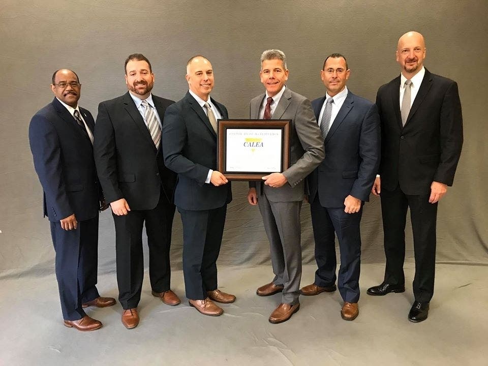 Pictured: Chief Lynch, Captain Burke, Sergeant Mourato, Officer Correia and CALEA Commissioners