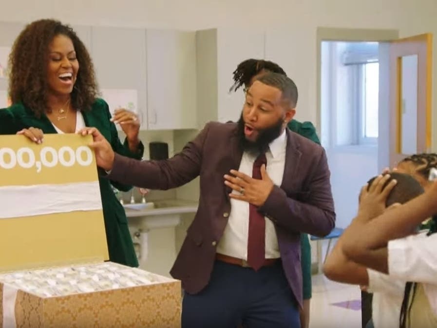 Former First Lady Michelle Obama visited Randle Highlands Elementary in D.C., where she surprised teachers and students with computers, iPads and $100,000.