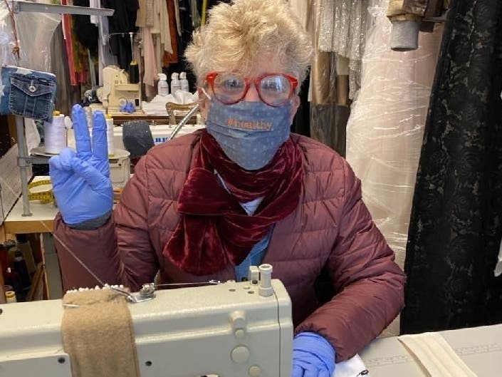 Pictured: Nancy Sinoway sewing masks.