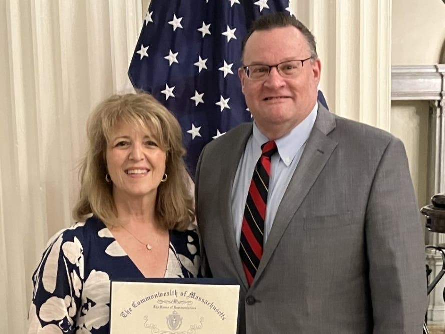 Representative Brad Jones presents a House citation to Lynnfield's Ellen Crawford, whom he nominated for the 2026 Commonwealth Heroine Award. Crawford was among 147 award recipients across the state honored at a June 24 State House ceremony.