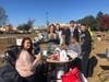 Chapter members count the fruit of their work for the day at the yard sale