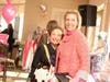 Dr. Irene Hrusovsky (left) posed for a photo with the coveted Tory Burch bag donated by Carla Zuniga (right).