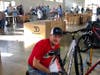 A volunteer assembles a bike at the bike build.