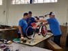 Volunteers assemble a bike at the bike build.