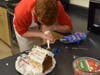 A student decorates a gingerbread house for Dublin High's annual competition.