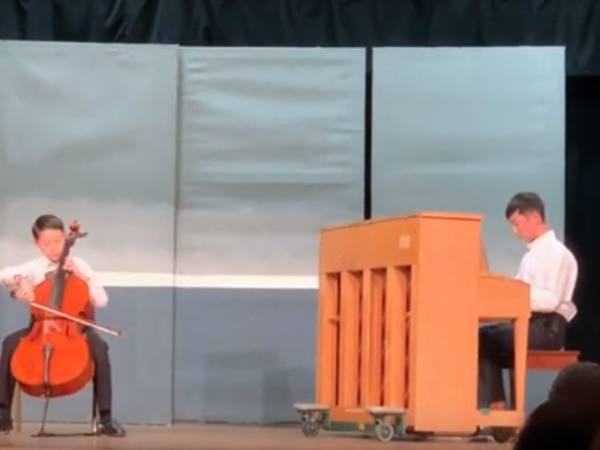 Michael Oliveira and Remon Wang in their debut middle school talent show performance.