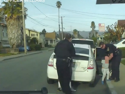 Body camera footage shows an officer removing the trashing child from the car.