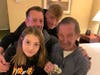 "Big" Reg Nicolay (far right) in his hotel room. Granddaughter Emi (bottom-left), son Reggie (middle-left) and grandson Evan surprised him with new clothes and items.