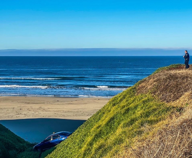 A car stuck on the beach near Sunset Beach.