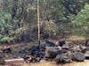 A smoldering pile of debris at the fire site.