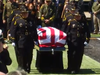 Sgt. Damon Gutzwiller's casket is carried to the stage at a memorial service in his memory.