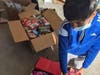 Adi Jain boxes food collected through his food drive.
