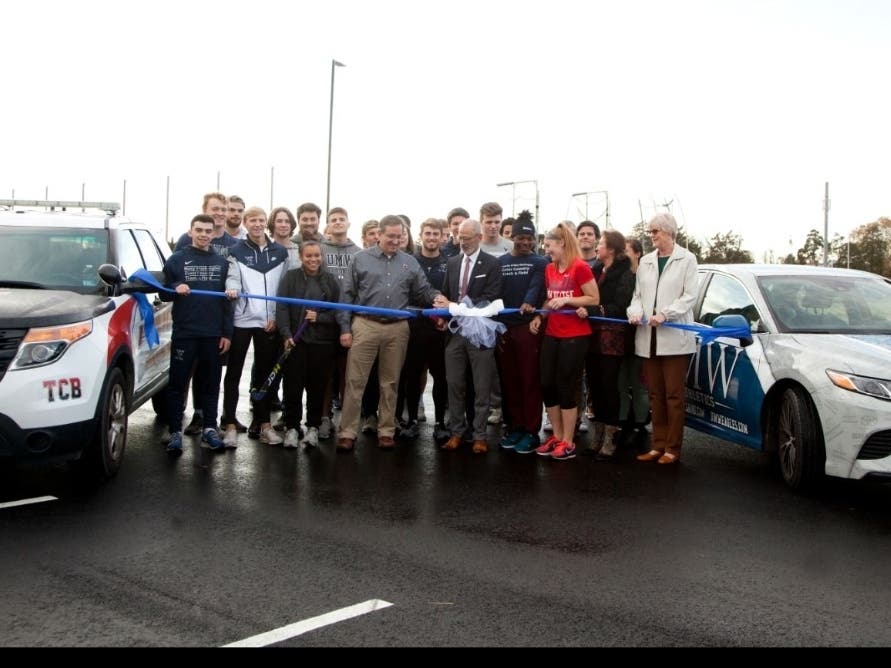 UMW coaches and athletes, together with city officials, attended Nov. 22 ribbon cutting for the expanded parking lot.