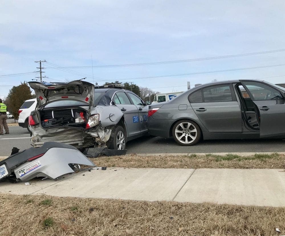 A Virginia State Police car was struck Sunday during a traffic stop, with the impact pushing it into the rear of a BMW sedan that had been stopped.