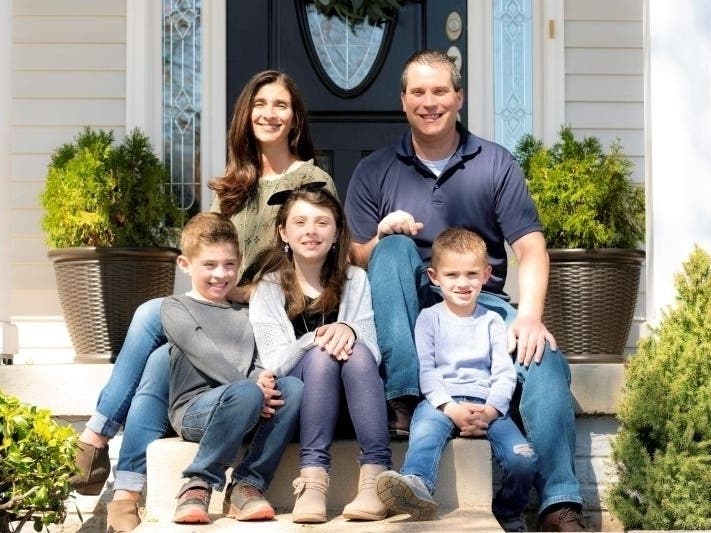 Manassas photographer Sandy Schaeffer takes a coronavirus-safe photo of a family on their front steps in Manassas.