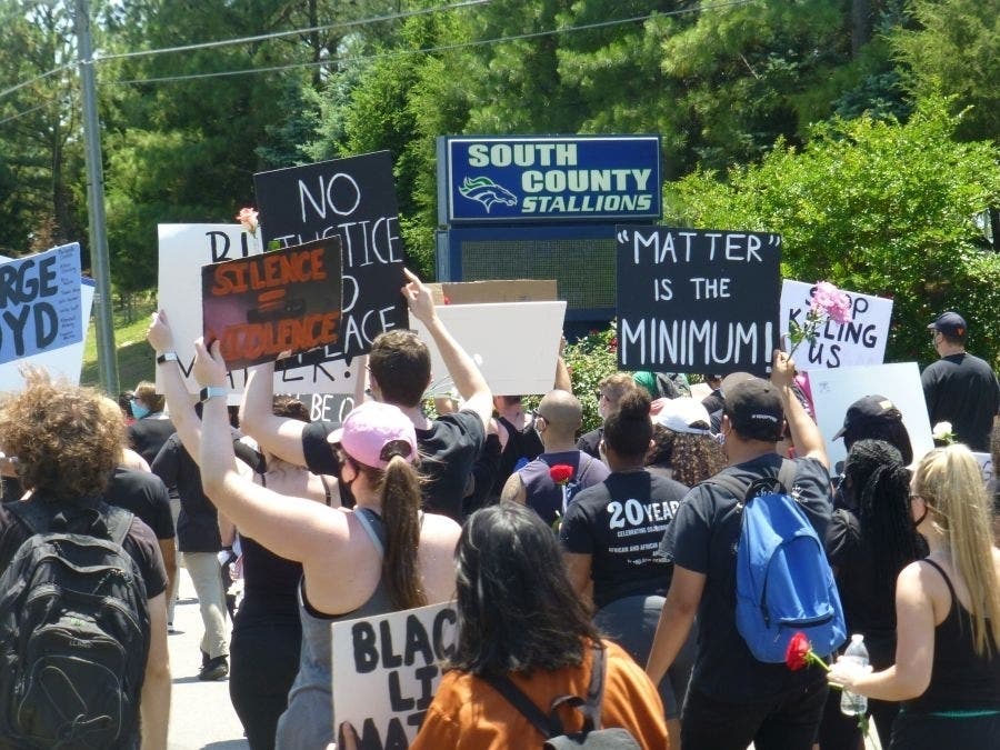 Hundreds of people rallied and marched at an event in Lorton on Saturday, organized by alumni of South County High School, against racial injustice.