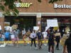 Fairfax County residents march through Greenbriar Town Center in Chantilly Sunday afternoon as part of a demonstration against racial injustice.