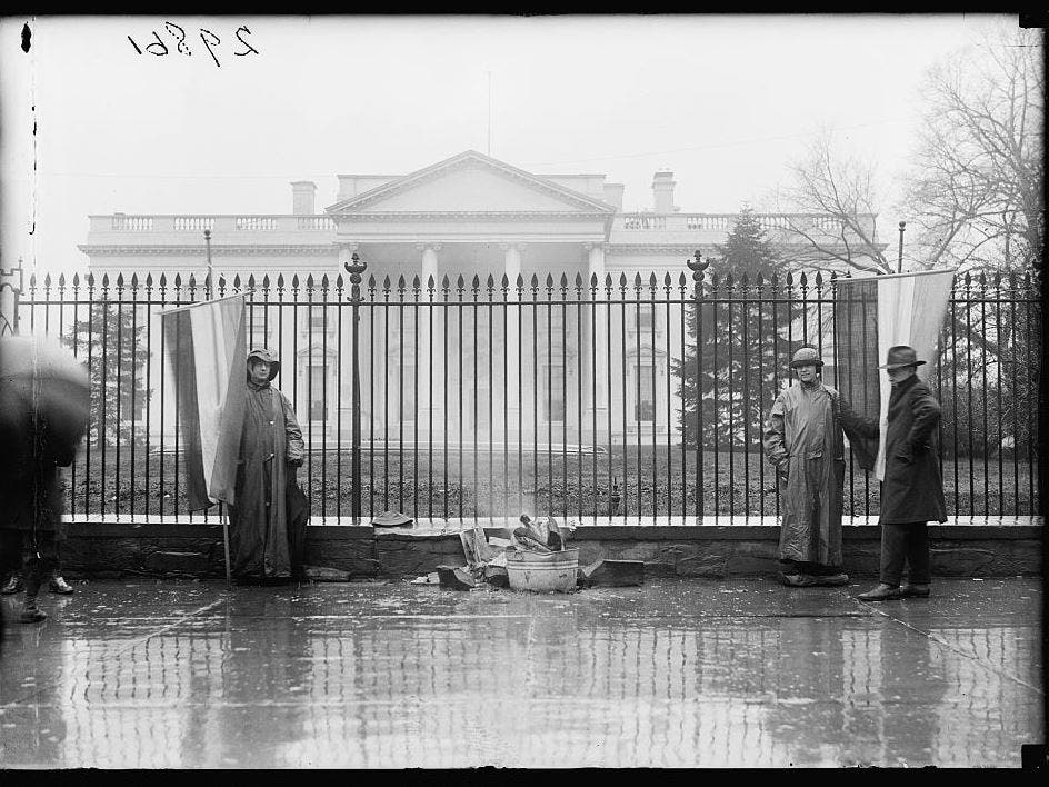 Women protest for the right to vote outside the White House in 1918.