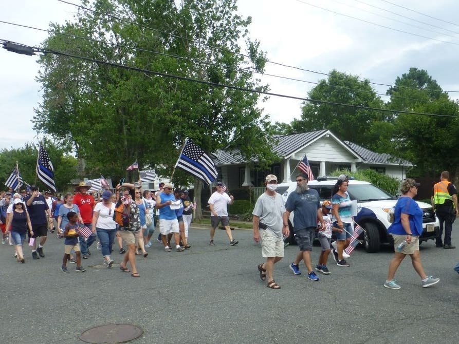 Demonstrators march through a residential area of Fredericksburg on June 28 to show their support for the police.