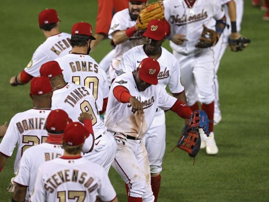 Nationals players bumped hips, instead of the traditional hand-shake, after their Saturday night victory against the Yankees.