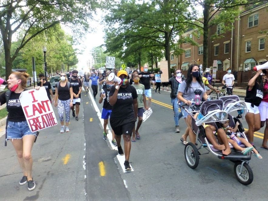 About 100 people marched more than three miles in Arlington Saturday afternoon for racial justice and police reform.
