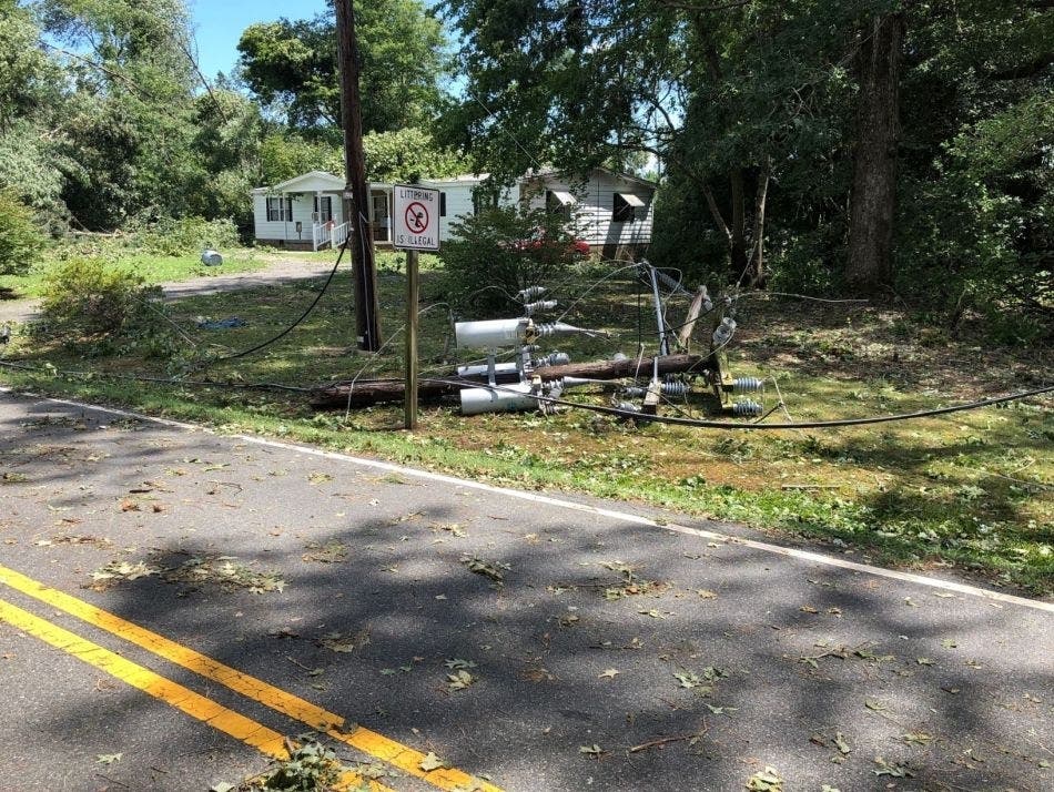 The Virginia Department of Transportation and utility crews cleared a road Tuesday in Lancaster County in the wake of Tropical Storm Isaias.