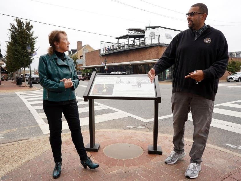 Fredericksburg Mayor Mary Katherine Greenlaw and Vice-Mayor Charlie Frye Jr. reflect on the new panel display Tuesday at the corner of William and Charles Streets.
