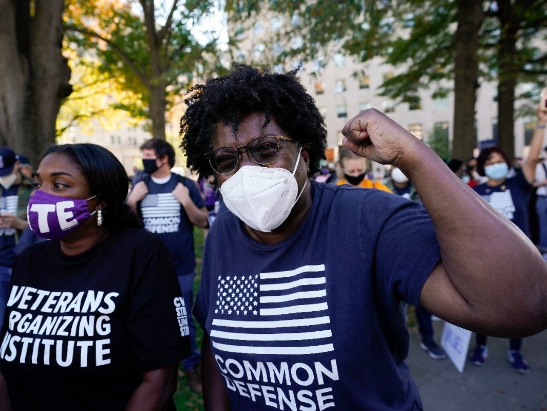 People gathered in Black Lives Matter Plaza in Washington, D.C., react to the presidential race being called in Joe Biden’s favor on Saturday.