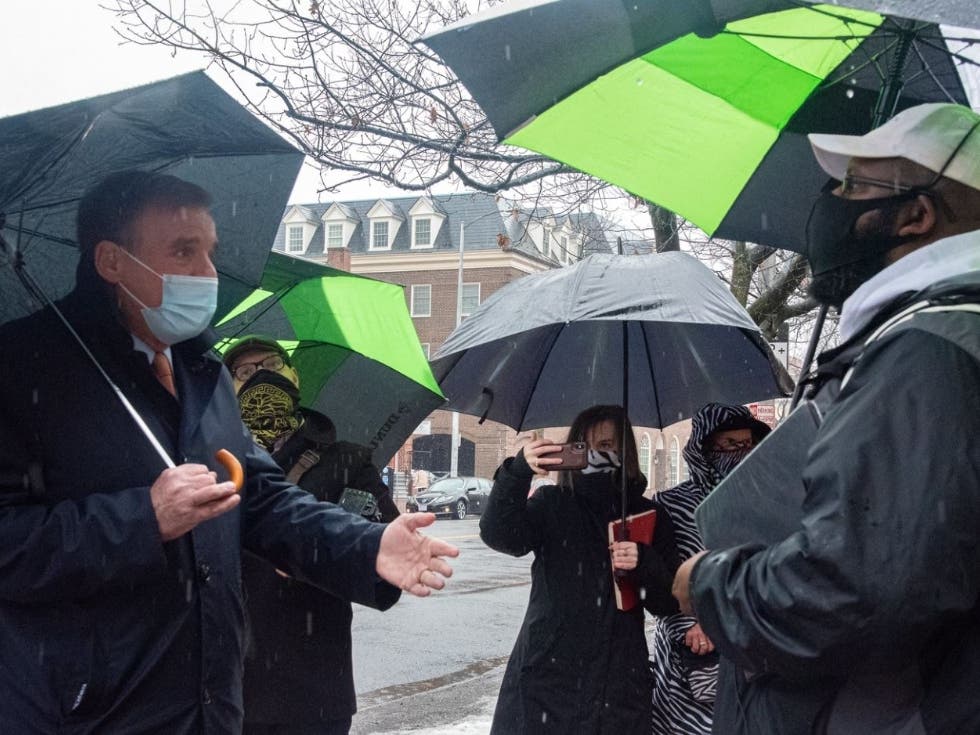 U.S. Sen. Mark Warner, left, goes on a tour of Alexandria on Monday led by City Councilman John Chapman, who operates the Manumission Tour Company.