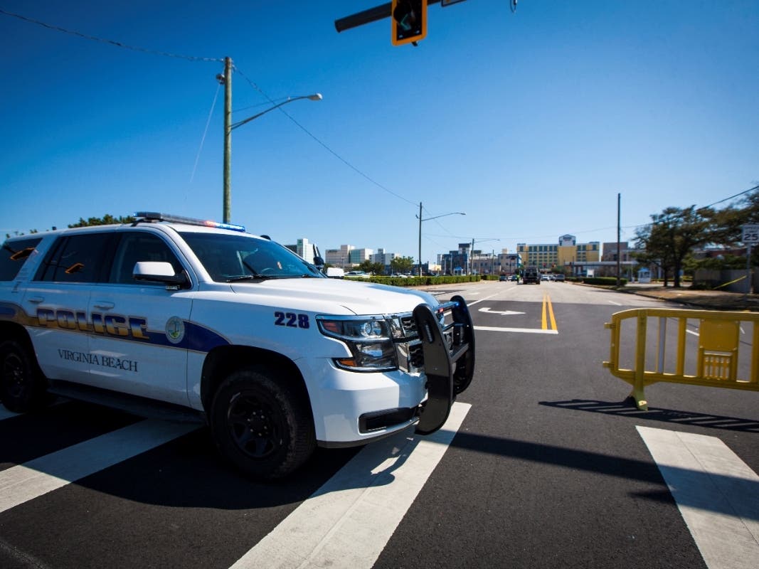 Virginia Beach police work the scene of multiple shootings on Friday, March 26 that resulted in the killing of two people and injuries to at least eight people.