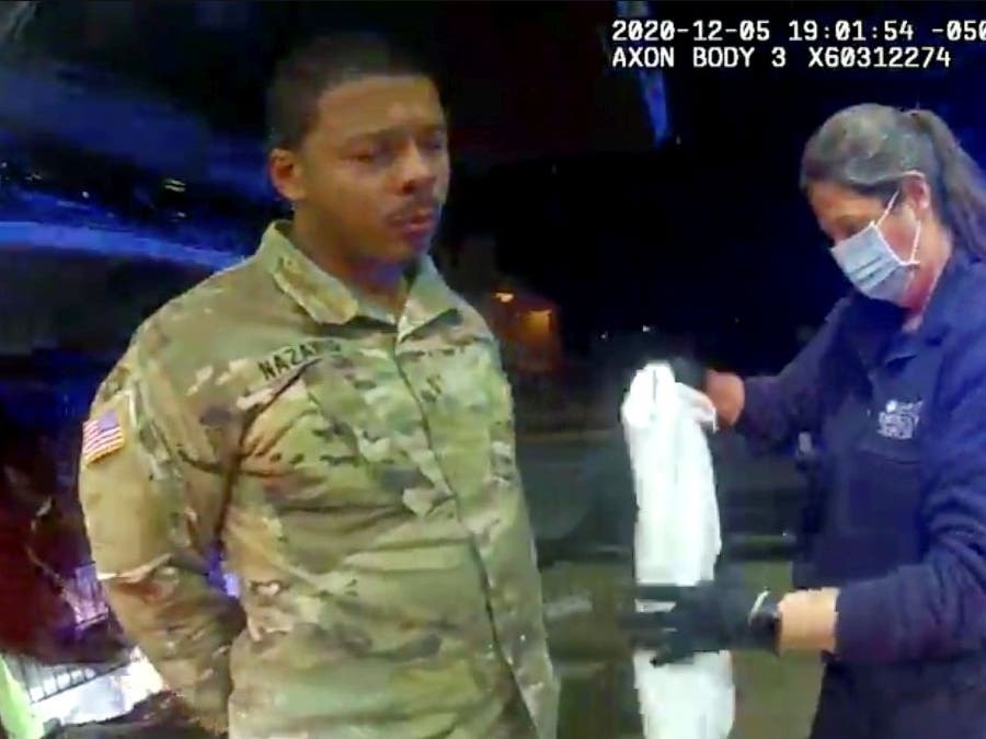 U.S. Army officer Caron Nazario is helped by an EMT after he was sprayed with an agent by a Windsor police officer after a traffic stop on Dec. 5, 2020.