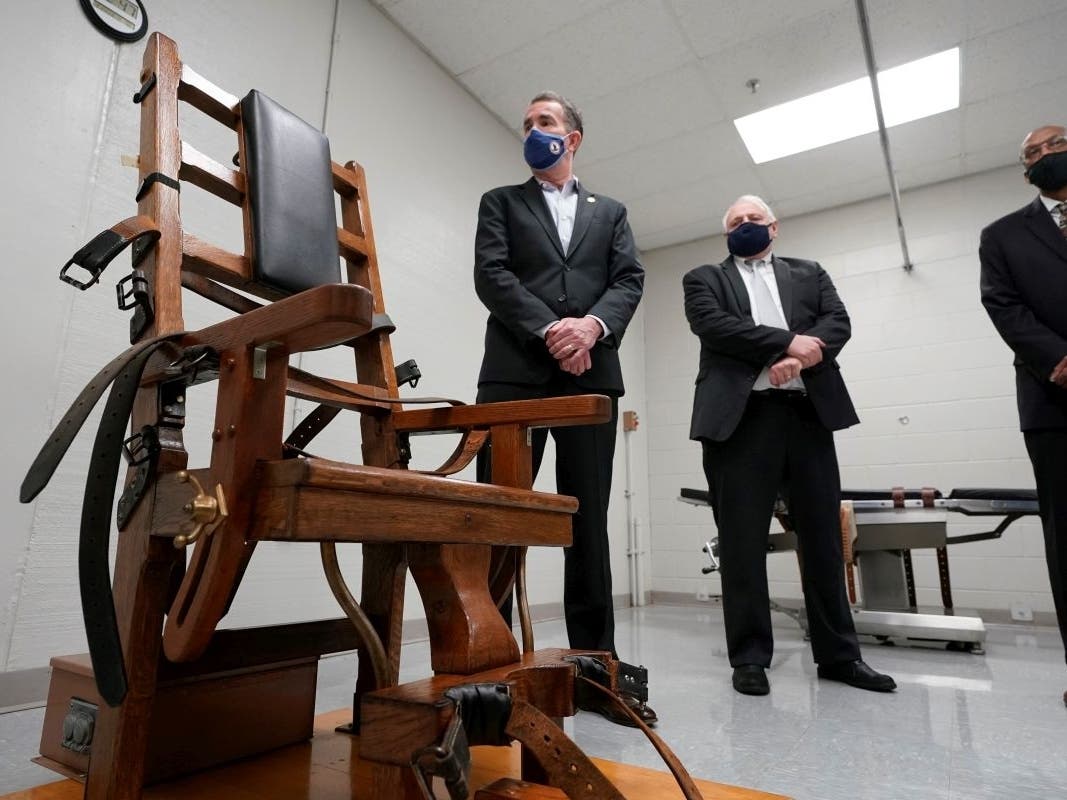 Virginia Gov. Ralph Northam looks over the electric chair in the death chamber at Greensville Correctional Center prior to signing a bill abolishing the penalty on March 24, 2021.