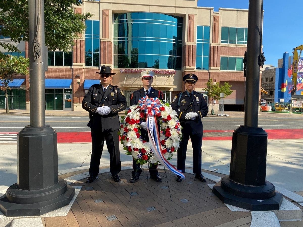 The 9/11 anniversary event at the Arlington County government center Friday morning included the presentation of colors by the Arlington County Public Safety Combined Honor Guard and the laying of a wreath to remember those killed at the Pentagon.