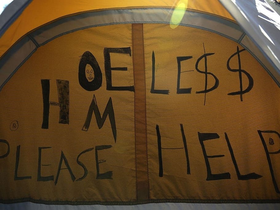 A D.C. worker clearing out a homeless encampment with heavy machinery in Northeast D.C. on Monday picked up a tent with a man still inside.