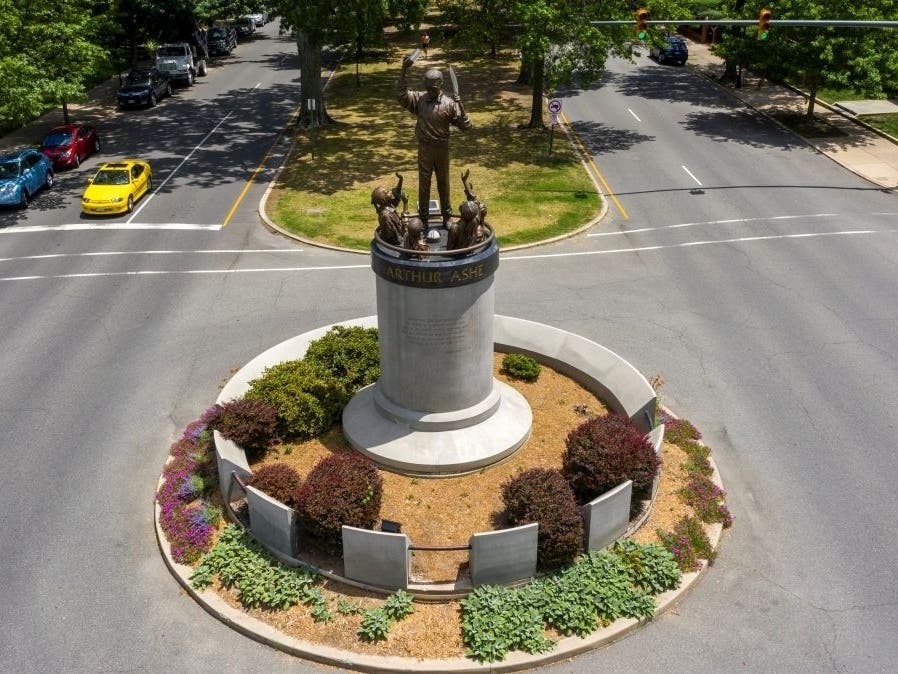 A statue of tennis star Arthur Ashe stands on Monument Avenue near downtown Richmond, about three miles from a city park where a mural of Ashe was vandalized Wednesday night or Thursday morning.