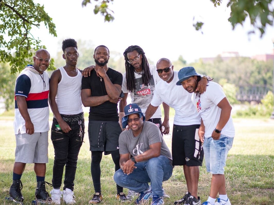 Craig Watson, a peer support specialist at Free Minds Book Club & Writing Workshop (front), with fellow Free Minds members, many of whom are trained peer supporters.