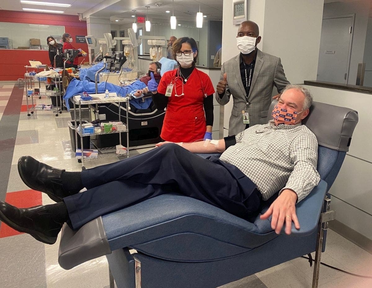 Employees at an American Red Cross blood donation center in Fairfax County celebrate with U.S. Sen. Tim Kaine Friday morning after the Virginia senator finished donating blood.