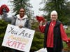Linda Johnsen (right), a former French teacher at George Mason High School, and a fellow 1992 graduate, cheer on Kate Fletcher as she passes through Falls Church as part of her 105-mile run to raise money for student scholarships.