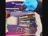 A TSA officer picks up a knife, one of many weapons that were detected in an Alexandria man's carry-on bag at Reagan National Airport on Wednesday.