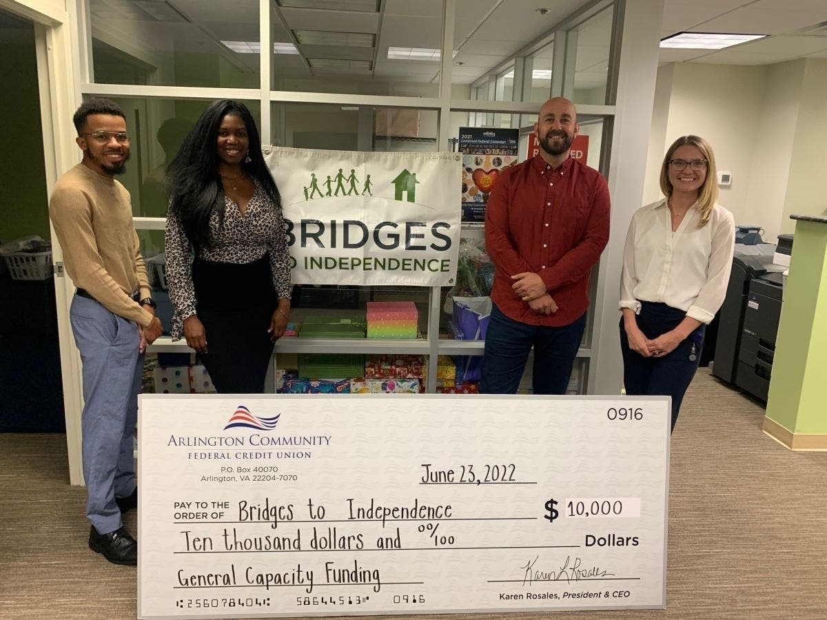From left, Jarius Hudson, Housing Stabilization Case Manager for Bridges; Jasmine Piggie, Development Coordinator for Bridges; Fraser Murdoch, Executive Director of Bridges; and Megan Niewold, Community Impact Manager for ACFCU.