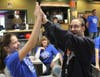 A SEASPAR participant and a St. Francis Xavier sixth-grader celebrate after leaving no pins standing.