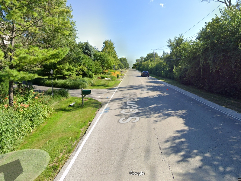 On the east side of Garfield Street (to the left), officials are considering building a sidewalk. Residents on the east side are opposed, saying the west side would be better. 